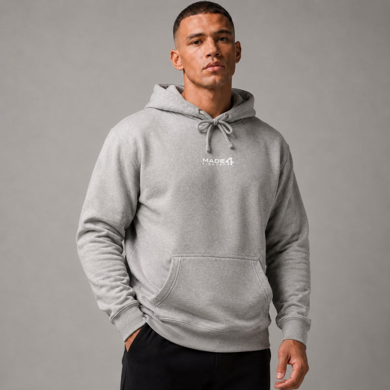 A man wearing a grey Made4Fighters hooded sweatshirt.